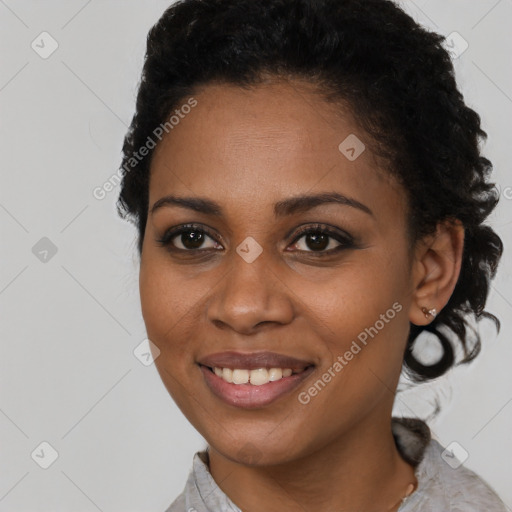 Joyful black young-adult female with short  black hair and brown eyes