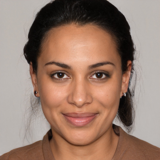 Joyful latino young-adult female with medium  brown hair and brown eyes