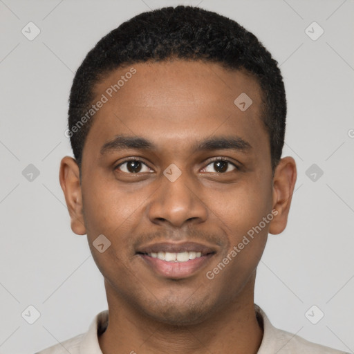 Joyful black young-adult male with short  black hair and brown eyes