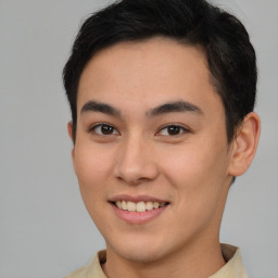 Joyful latino young-adult male with short  brown hair and brown eyes