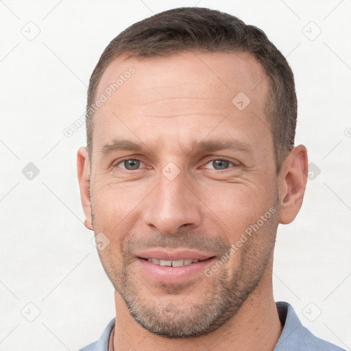 Joyful white adult male with short  brown hair and brown eyes