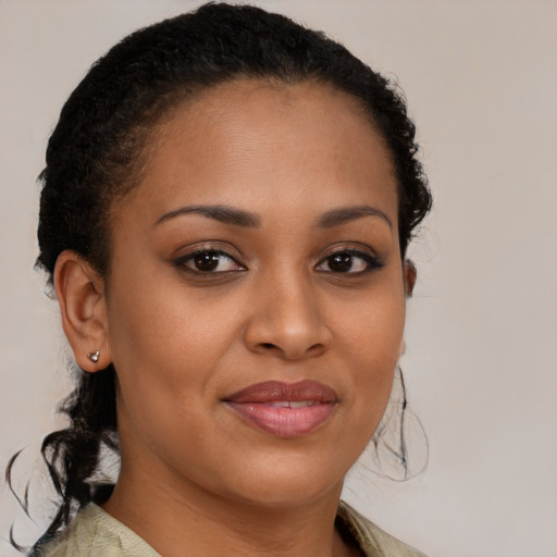 Joyful black young-adult female with medium  brown hair and brown eyes