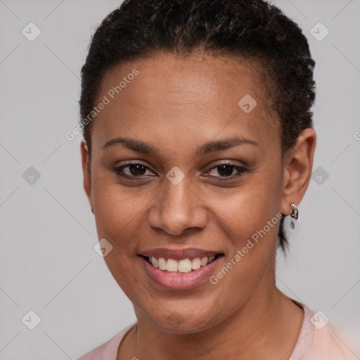 Joyful black young-adult female with short  brown hair and brown eyes