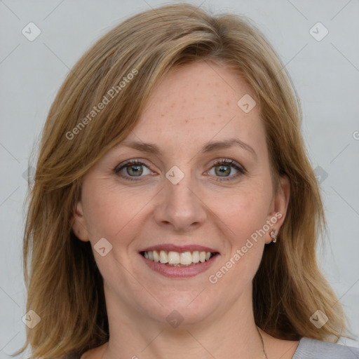 Joyful white adult female with medium  brown hair and blue eyes