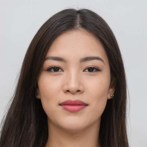 Joyful asian young-adult female with long  brown hair and brown eyes