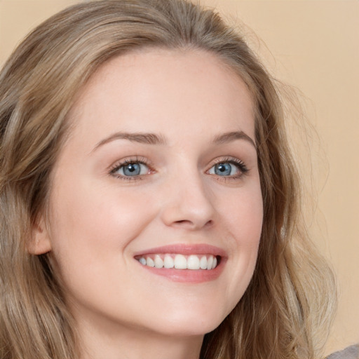 Joyful white young-adult female with long  brown hair and blue eyes