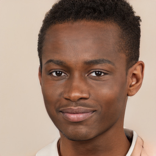 Joyful black young-adult male with short  brown hair and brown eyes