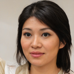 Joyful asian young-adult female with medium  brown hair and brown eyes