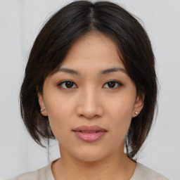 Joyful asian young-adult female with medium  brown hair and brown eyes