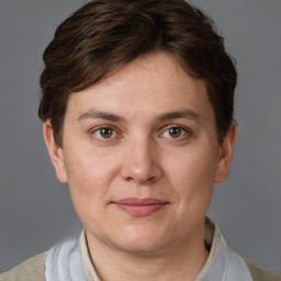 Joyful white young-adult female with short  brown hair and grey eyes