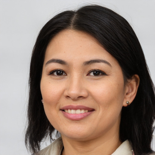 Joyful asian young-adult female with medium  brown hair and brown eyes