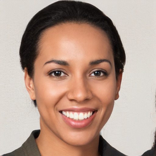 Joyful latino young-adult female with medium  black hair and brown eyes