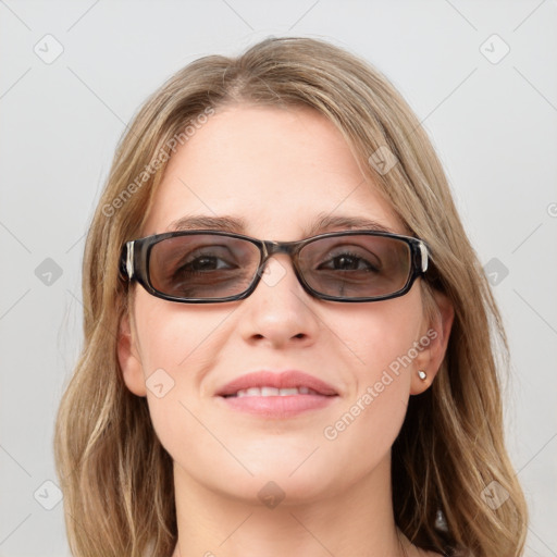 Joyful white young-adult female with long  brown hair and blue eyes