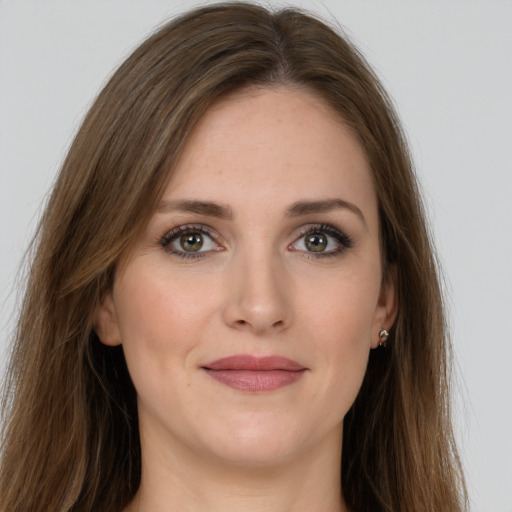 Joyful white young-adult female with long  brown hair and green eyes