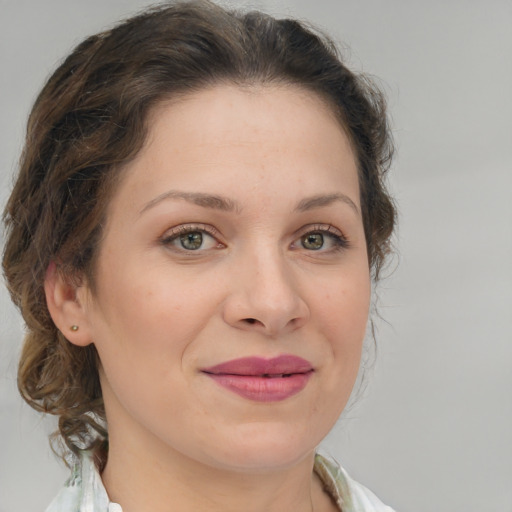 Joyful white young-adult female with medium  brown hair and green eyes