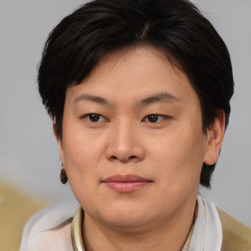 Joyful asian young-adult female with short  brown hair and brown eyes