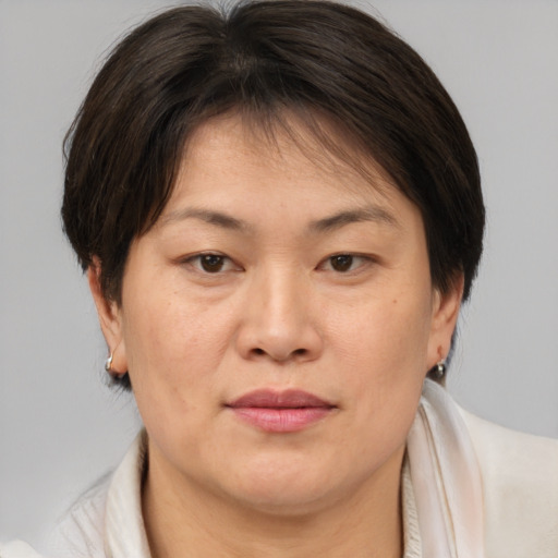 Joyful asian adult female with medium  brown hair and brown eyes