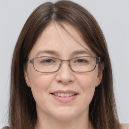 Joyful white adult female with long  brown hair and grey eyes