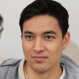 Joyful asian young-adult male with short  brown hair and brown eyes