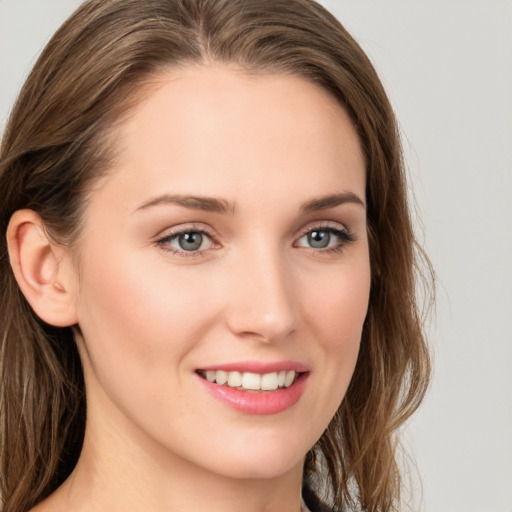 Joyful white young-adult female with long  brown hair and blue eyes