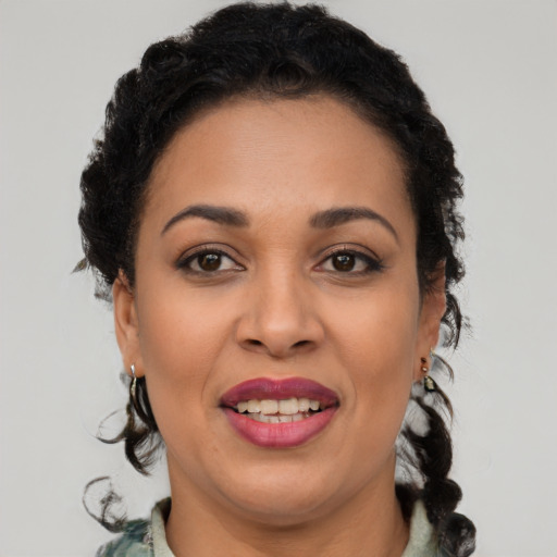 Joyful latino adult female with medium  brown hair and brown eyes