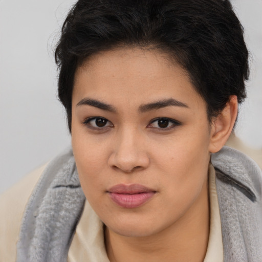 Joyful asian young-adult female with long  brown hair and brown eyes