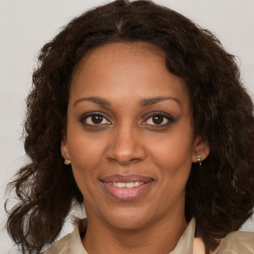 Joyful black adult female with medium  brown hair and brown eyes
