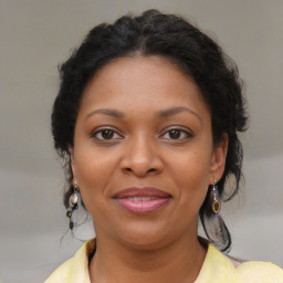 Joyful black young-adult female with medium  brown hair and brown eyes