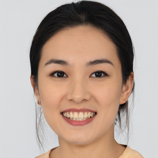 Joyful white young-adult female with medium  black hair and brown eyes
