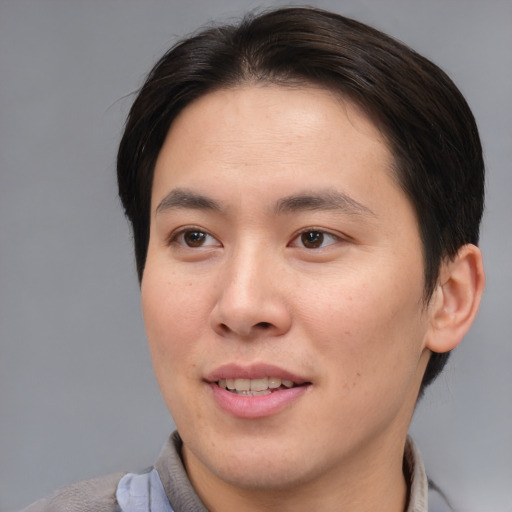 Joyful asian young-adult male with short  brown hair and brown eyes