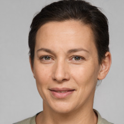 Joyful white adult female with short  brown hair and grey eyes