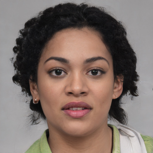 Joyful latino young-adult female with medium  black hair and brown eyes