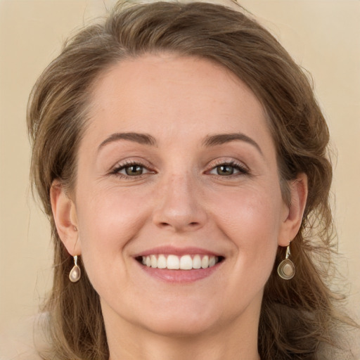 Joyful white young-adult female with long  brown hair and green eyes