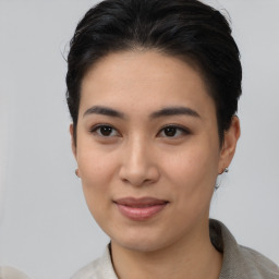 Joyful asian young-adult female with short  black hair and brown eyes