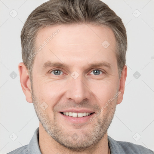 Joyful white adult male with short  brown hair and grey eyes