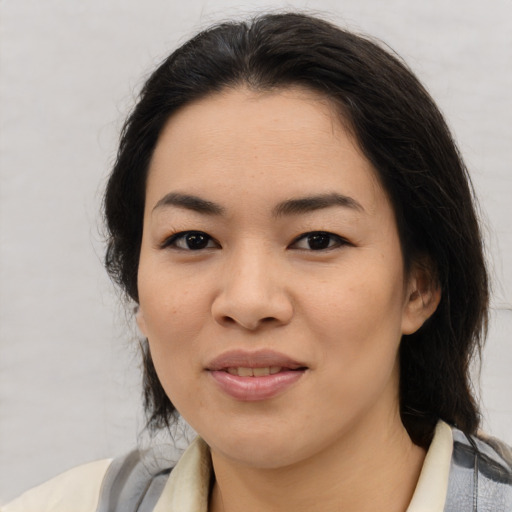 Joyful asian young-adult female with medium  brown hair and brown eyes