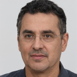 Joyful white adult male with short  black hair and brown eyes
