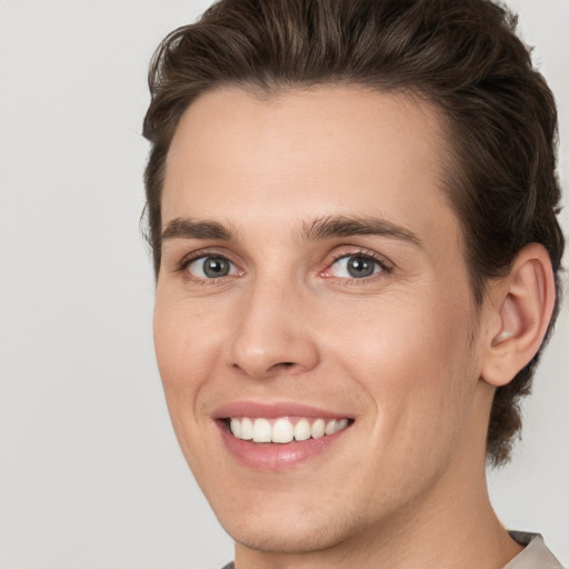 Joyful white young-adult male with medium  brown hair and brown eyes