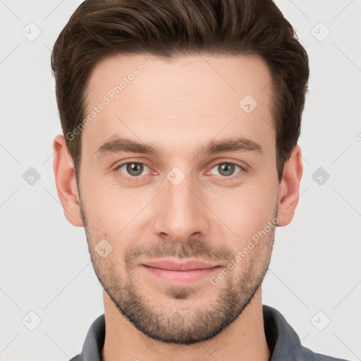 Joyful white young-adult male with short  brown hair and grey eyes