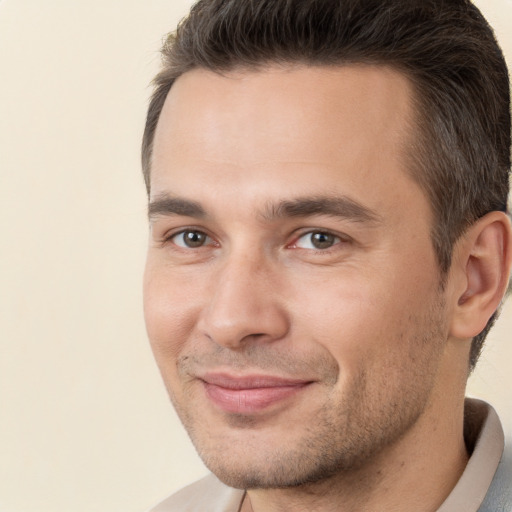 Joyful white young-adult male with short  brown hair and brown eyes