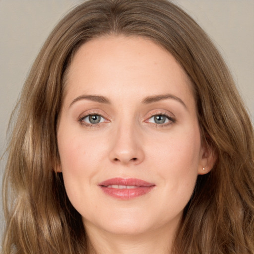 Joyful white young-adult female with long  brown hair and grey eyes