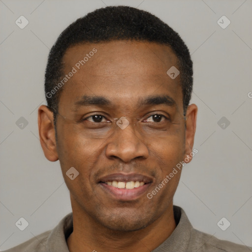Joyful black adult male with short  black hair and brown eyes