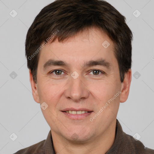 Joyful white adult male with short  brown hair and brown eyes