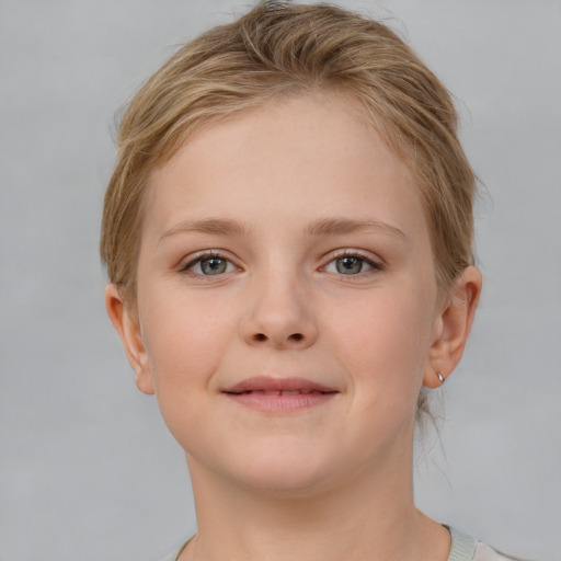 Joyful white child female with short  brown hair and grey eyes