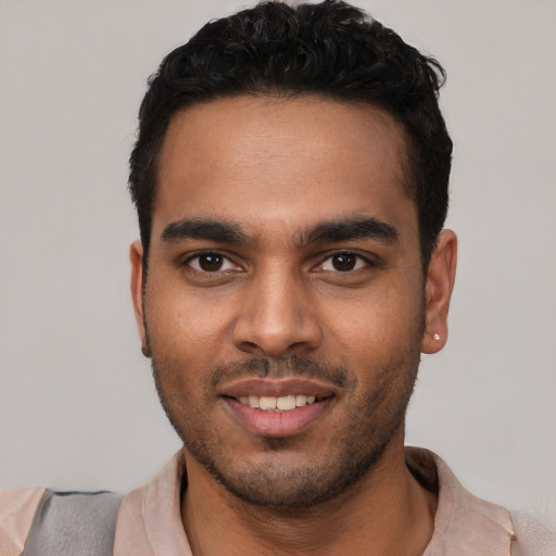 Joyful white young-adult male with short  black hair and brown eyes