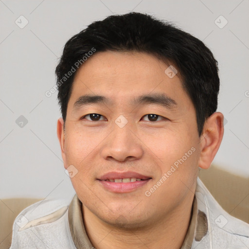 Joyful asian young-adult male with short  brown hair and brown eyes