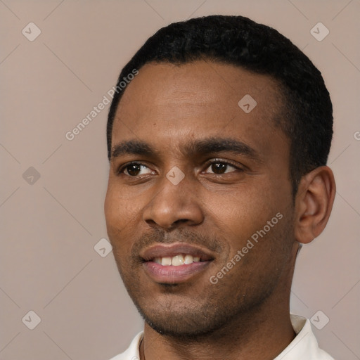 Joyful black young-adult male with short  black hair and brown eyes