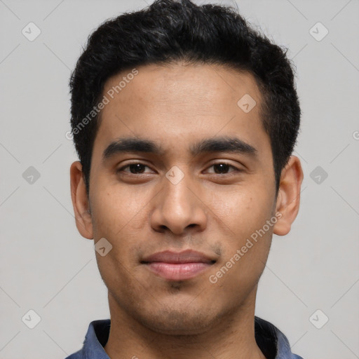 Joyful latino young-adult male with short  black hair and brown eyes