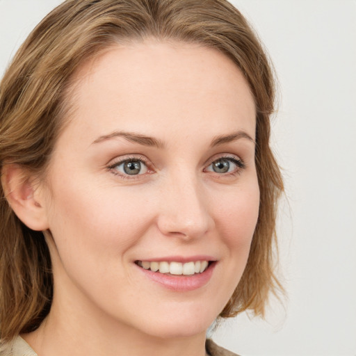 Joyful white young-adult female with medium  brown hair and blue eyes