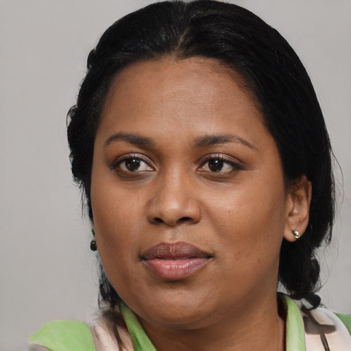 Joyful black young-adult female with medium  black hair and brown eyes